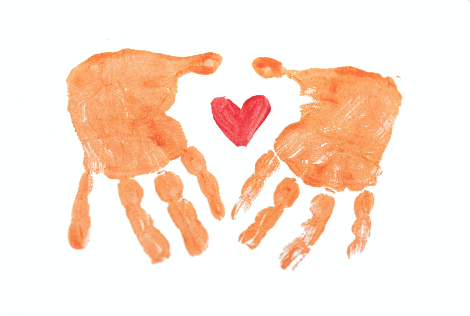Water color painting of two hands surrounding a heart.